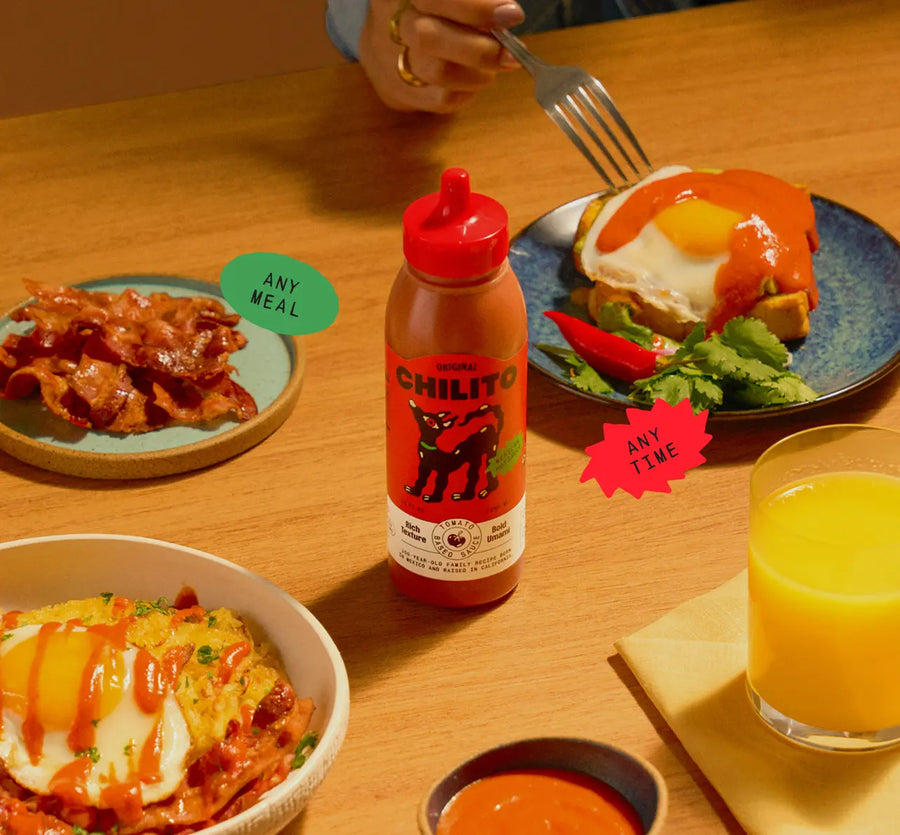 Chilito hot sauce bottle on a table with food and drinks