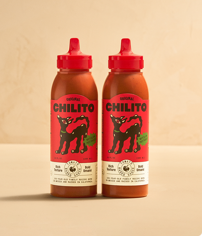Two bottles of Chilito hot sauce on a beige background
