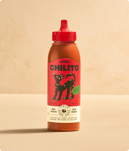 Chilito hot sauce bottle with red cap on a beige background