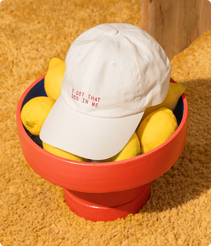 White cap with text on a red stand with lemons